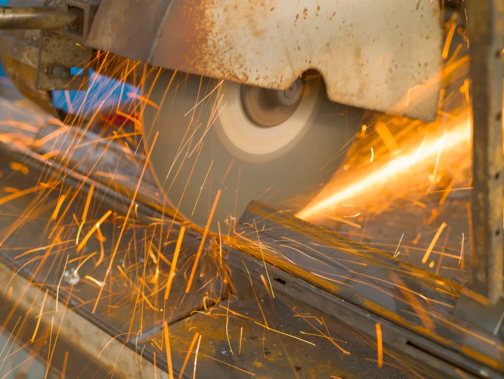 Metalworking. Cutting a metal profile with a circular saw. Natural light
